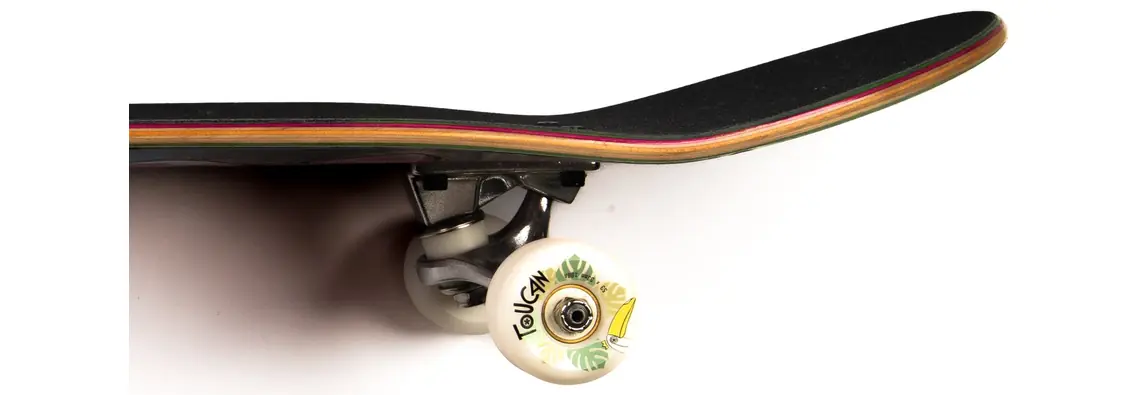 Skateboard seen edge-on: griptape along the top and the seven-ply stack in the edge
