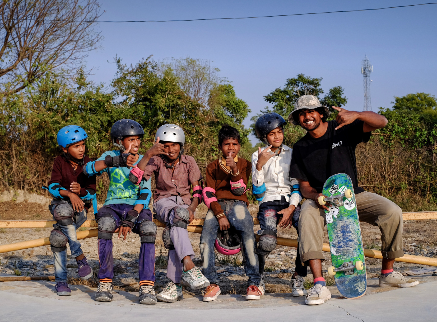 Coach with students wearing helmets and protective pads