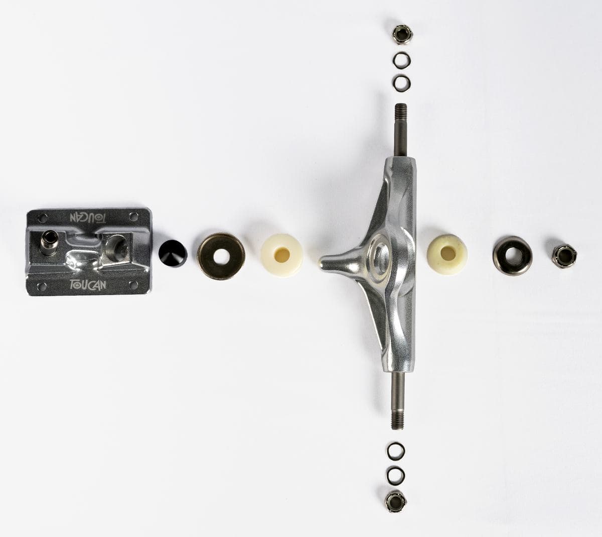 One skateboard truck taken fully apart and laid out in stack order on a flat white background