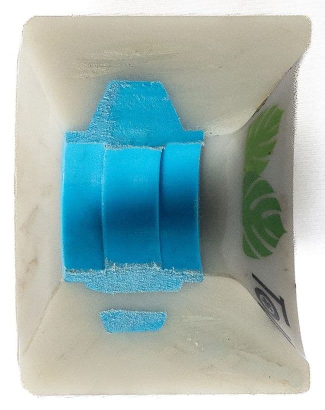 A skateboard wheel cut clean through the axle, showing the urethane body, the core and the bearing seat